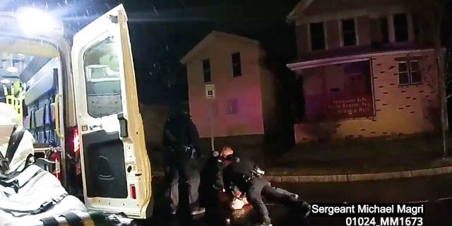 Rochester police officers holding down Daniel Prude, who had run naked through the streets of the western New York city, this past March. He died of asphyxiation after police put a hood over his head, then pressed his face into the pavement for two minutes, according to video and records released last week by the man's family.