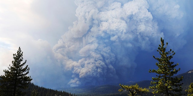 Huntington Lake is seen in the foreground as the Creek Fire burns in the distance Saturday, Sept. 5, 2020, about 35 miles northeast of Fresno, Calif.