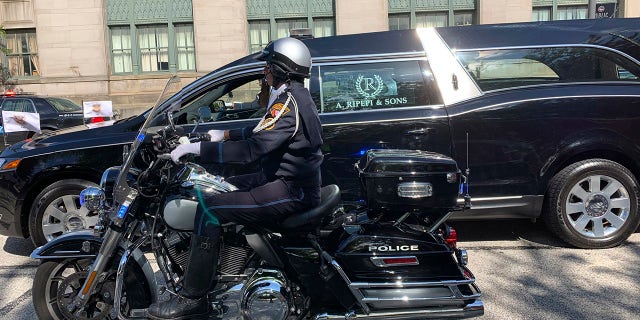 In this photo provided by the Cleveland Division of Fire, a hearse bearing the body of Detective James Skernivitz proceeds to the funeral home under police escort Saturday, Sept. 5, 2020. Skernivitz was shot and killed along with a police informant while sitting in an unmarked car during an undercover operation in Cleveland, Ohio, on Thursday, Sept. 3, 2020. (Lt. Mike Norman/Cleveland Division of Fire via AP)