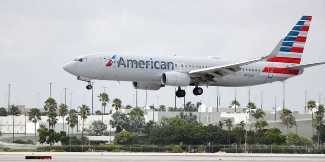 FILE: An American Airlines Boeing 737-823 lands at Miami International Airport, Monday, July 27, 2020, in Miami. 