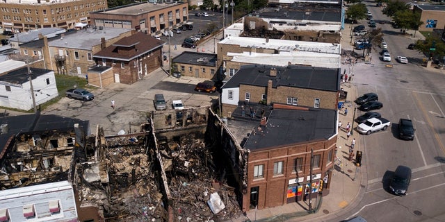 This Aug. 28, 2020 aerial photo shows damage to businesses in Kenosha, Wis. Police in Kenosha have arrested dozens of people since a white officer shot Jacob Blake in the back. (Sean Krajacic/The Kenosha News via AP)