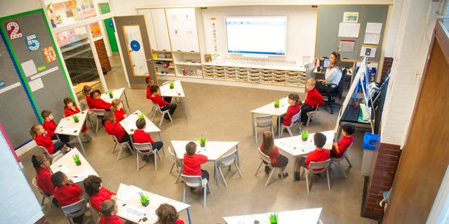 Pupils sit in a classroom on the first day back to school at Charles Dickens Primary School in London, Tuesday Sept. 1, 2020. (Dominic Lipinski/PA via AP)