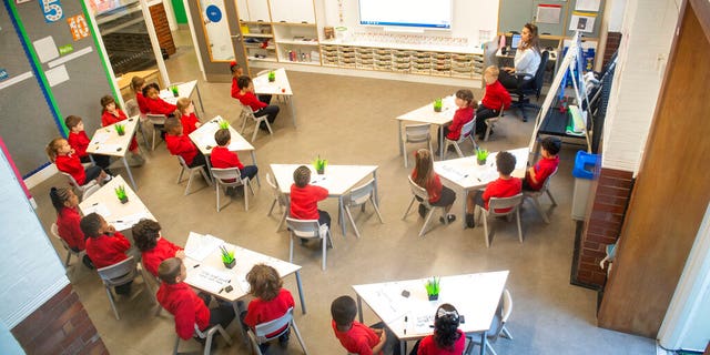 Pupils sit in a classroom on the first day back to school at Charles Dickens Primary School in London, Tuesday Sept. 1, 2020. (Dominic Lipinski/PA via AP)