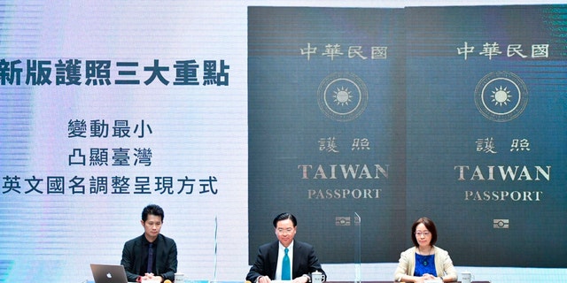 In this Sep. 2, 2020, photo released by the Executive Yuan, Taiwan's Foreign Minister Joseph Wu, center, and Executive Yuan spokesperson Evian Ting, left, and Director of Consular Affairs Bureau Phoebe Yeh attends a news conference to reveal the new Taiwan passport in Taipei, Taiwan. (Executive Yuan via AP)