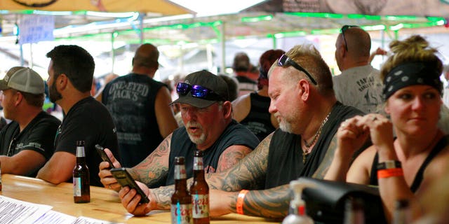 In this Aug. 7 file photo, people congregate at One-Eyed Jack's Saloon during the 80th annual Sturgis Motorcycle Rally in Sturgis, S.D. (AP Photo/Stephen Groves File)