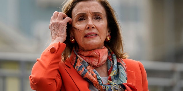 House Speaker Nancy Pelosi pulls back her hair while speaking about her visit to a hair salon during a news conference at the Mission Education Center Elementary School Wednesday, Sept. 2, 2020, in San Francisco. (AP Photo/Eric Risberg)