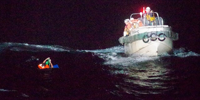 In this photo released by the 10th Regional Japan Coast Guard Headquarters, a Filipino crewmember of a Panamanian cargo ship is rescued by Japanese Coast Guard members in the waters off the Amami Oshima, Japan Wednesday, Sept. 2, 2020. Japanese rescuers have safely plucked the crewmember from the sea while searching for the cargo ship carrying more than 40 crew and thousands of cows went missing after sending a distress call off the southern Japanese island. (The 10th Regional Japan Coast Guard Headquarters via AP)