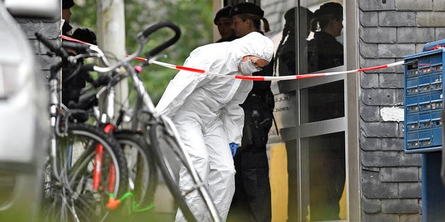 A forensic officer leaves a house, where five dead children were found in Solingen, Germany, Thursday, Sept. 3, 2020. Police say the five children have been found dead at an apartment in the western German city, and their mother is suspected of killing them. (AP Photo/Martin Meissner)
