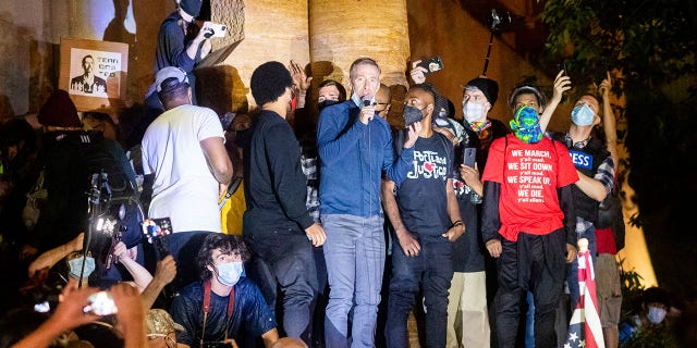 Portland Mayor Ted Wheeler speaks to Black Lives Matter protesters in Portland, Ore in July. (Associated Press)