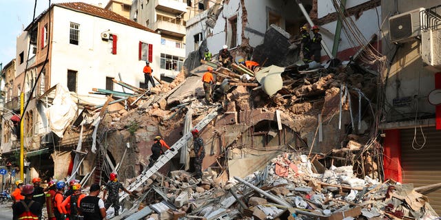 Chilean and Lebanese rescuers search the rubble of a building that collapsed in last month's massive explosion, after receiving signs that a survivor may be under the rubble, in Beirut, Lebanon, on September 3. 