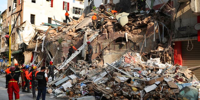 Chilean and Lebanese rescuers search in the rubble of a building that was collapsed in last month's massive explosion, after getting signals there may be a survivor under the rubble, in Beirut, Lebanon, Sept. 3.