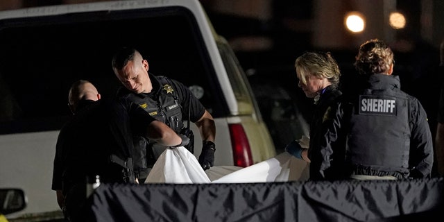 The body of Michael Reinoehl is lifted onto a stretcher in the early morning hours of Friday, Sept. 4, 2020, in Lacey, Wash. (AP Photo/Ted S. Warren)