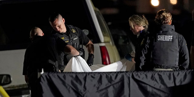 The body of Michael Reinoehl is lifted onto a stretcher in the early morning hours of Friday, Sept. 4, 2020, in Lacey, Wash.(AP Photo/Ted S. Warren)