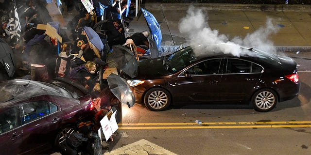 Demonstrators clash with police officers a block from the Public Safety Building in Rochester, N.Y., Sept. 4, 2020, after a rally and march protesting the death of Daniel Prude. (Associated Press)