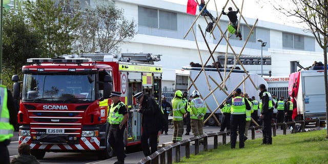 Police and fire services at the scene, outside Broxbourne newsprinters as protesters continue to block the road, in Broxbourne, Hertfordshire, England, Saturday, Sept. 5, 2020. (Yui Mok/PA via AP)