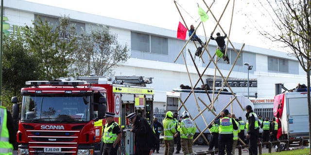 Police and fire services at the scene, outside Broxbourne newsprinters as protesters continue to block the road, in Broxbourne, Hertfordshire, England, Saturday, Sept. 5, 2020. (Yui Mok/PA via AP)