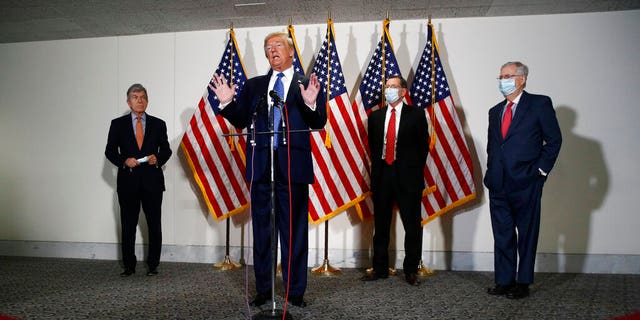 FILE: President Donald Trump speaks with reporters after meeting with Senate Republicans at their weekly luncheon on Capitol Hill in Washington. 
