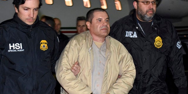 Authorities escort Mexican drug lord Joaquin "El Chapo" Guzman, center, from a plane in Ronkonkoma, N.Y.  