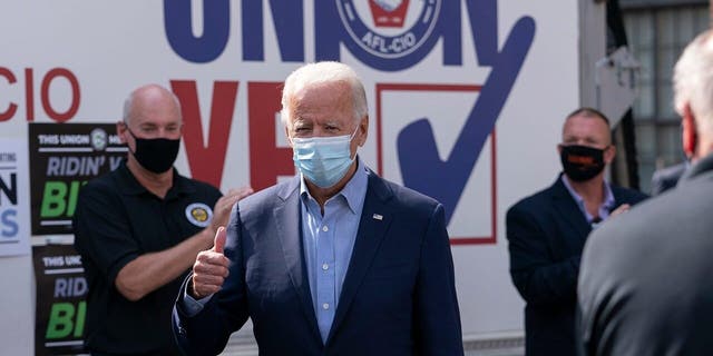 Democratic presidential candidate former Vice President Joe Biden gives the thumbs up as he arrives to pose for photographs with union leaders outside the AFL-CIO headquarters in Harrisburg, Pa., Sept. 7. (AP Photo/Carolyn Kaster)