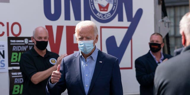 Democratic presidential candidate former Vice President Joe Biden gives the thumbs up as he arrives to pose for photographs with union leaders outside the AFL-CIO headquarters in Harrisburg, Pa., Sept. 7. (AP Photo/Carolyn Kaster)