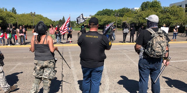 Supporters of President Donald Trump and Black Lives Matter protesters confront each other at the Oregon state Capitol in Salem, Ore. on Monday, Sept. 7, 2020. (AP Photo/Andrew Selsky)