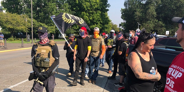 Members of the right-wing group the Proud Boys arrive in Salem, Ore., on Monday Sept. 7, 2020 for a pro-Donald Trump rally at the Capitol. (AP Photo/Andrew Selsky)