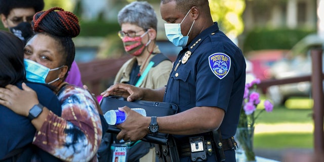 Rochester Police Chief La'Ron Singletary, right, seen before a community meeting in Rochester, N.Y., Thursday, Sept. 3, 2020. (AP Photo/Adrian Kraus)