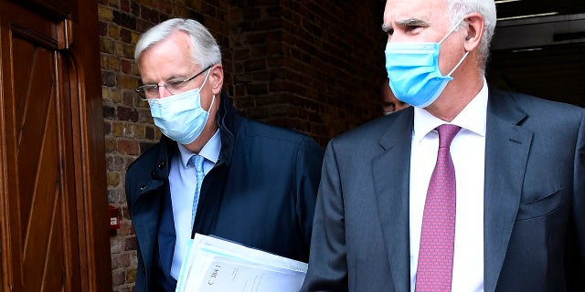 EU Chief negotiator Michel Barnier, left, arrives at St. Pancras international train station in London, Wednesday, Sept. 9, 2020. UK and EU officials begin the eighth round of Brexit negotiations in London. (AP Photo/Alberto Pezzali)