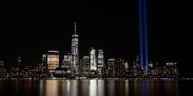 In this Sept. 11, 2017, file photo, the Tribute in Light illuminates in the sky above the Lower Manhattan area of New York, as seen from across the Hudson River in Jersey City, N.J. (AP Photo/Jason DeCrow, File)