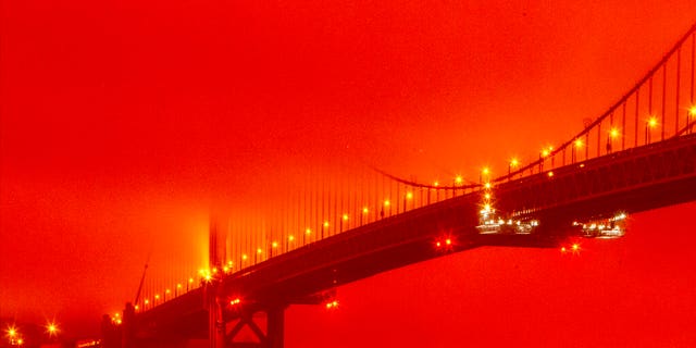 In this photo provided by Frederic Larson, the Golden Gate Bridge is seen at 11 a.m. PT, Sept. 9, in San Francisco, amid a smoky, orange hue caused by the ongoing wildfires. (Frederic Larson via AP)