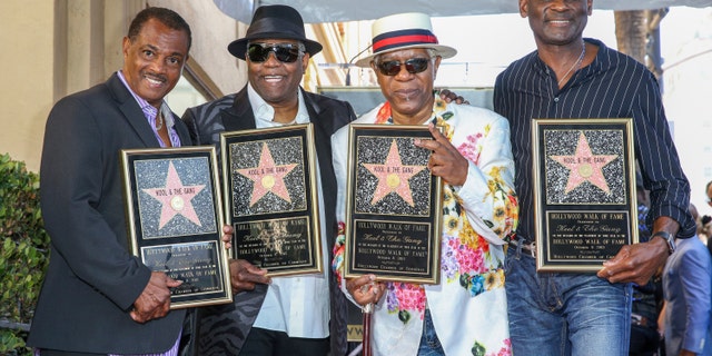 FILE - Robert 'Kool' Bell, from left, Ronald 'Khalis' Bell, Dennis 'DT' Thomas and George Brown attend a ceremony honoring Kool & The Gang with a star on The Hollywood Walk of Fame on Oct. 8, 2015, in Los Angeles. (Photo by Rich Fury/Invision/AP, FILE)