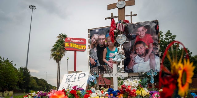 A tribute to Nicolas Chavez, 27, who was shot and killed April 21 by several police officers during a confrontation in Houston's Denver Harbor neighborhood, sits at the site of the shooting along Interstate 10 on Thursday. The officers involved have been fired but are appealing the dismissals. (Mark Mulligan/Houston Chronicle via AP)