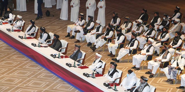 Taliban negotiator Abbas Stanikzai, fifth right, with his delegation attend the opening session of the peace talks between the Afghan government and the Taliban in Doha, Qatar, Saturday, Sept. 12, 2020. (AP Photo/Hussein Sayed)