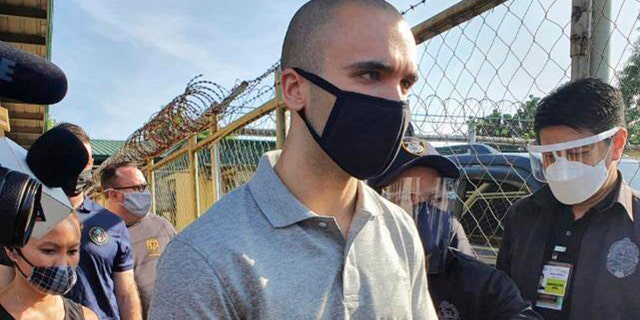 In this photo provided by the Philippines' Bureau of Immigration, U.S. Marine Lance Cpl. Joseph Scott Pemberton gets ready to leave Camp Aguinaldo on his way to the airport in Quezon city, Philippines, Sunday, Sept. 13, 2020. Pemberton, a U.S. Marine convicted of killing a Filipino transgender woman, was deported Sunday after a presidential pardon cut short his detention in a case that renewed outrage over a pact governing American military presence in the Philippines. (Bureau of Immigration via AP)