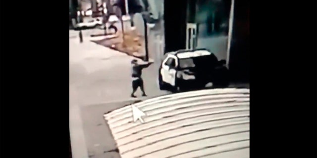 A screen grab from a security camera video released the Los Angeles County Sheriff's Department shows a gunman walking up to sheriff's deputies and opening fire without warning or provocation in Compton, Calif., on Saturday, Sept. 12, 2020. (Los Angeles County Sheriff's Department via AP)