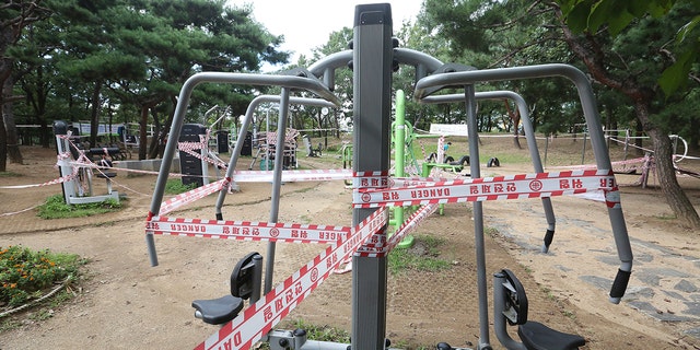 The use of public sports facilities is banned amid social distancing rules at a park in Goyang, South Korea, Sunday, Sept. 13, 2020. (AP Photo/Ahn Young-joon)