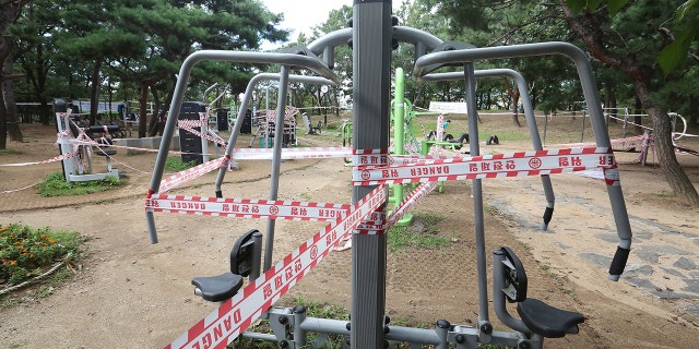 The use of public sports facilities is banned amid social distancing rules at a park in Goyang, South Korea, Sunday, Sept. 13, 2020. (AP Photo/Ahn Young-joon)