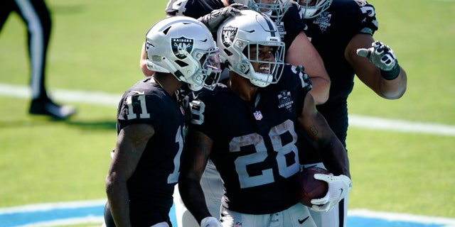 Las Vegas Raiders running back Josh Jacobs (28) celebrates after scoring during the second half of an NFL football game against the Carolina Panthers Sunday, Sept. 13, 2020, in Charlotte, N.C. (AP Photo/Brian Blanco)