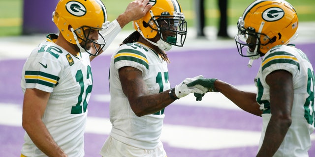 Green Bay Packers wide receiver Davante Adams, center, celebrates with teammates Aaron Rodgers, left, and Marquez Valdes-Scantling, right, after catching a 1-yard touchdown pass during the second half of an NFL football game against the Minnesota Vikings, Sunday, Sept. 13, 2020, in Minneapolis. (AP Photo/Bruce Kluckhohn)