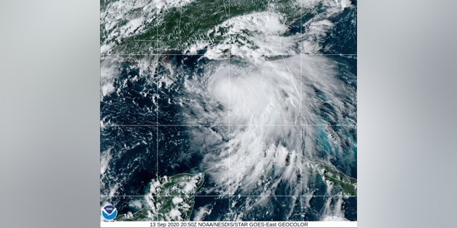 This satellite photo provided by the National Oceanic and Atmospheric Administration shows Tropical Storm Sally, Sunday, Sept. 13, 2020, at 2050 GMT. Sally churned northward on Sunday, poised to turn into a hurricane and send a life-threatening storm surge along the northern Gulf of Mexico. (NOAA via AP)