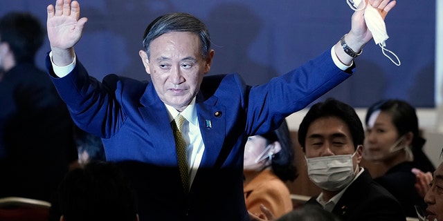 Japanese Chief Cabinet Secretary Yoshihide Suga acknowledges as he is elected as new head of Japan's ruling party at the Liberal Democratic Party's (LDP) leadership election Monday, Sept. 14, 2020, in Tokyo. The ruling LDP chooses its new leader in an internal vote to pick a successor to Prime Minister Shinzo Abe, who announced his intention to resign last month due to illness. (AP Photo/Eugene Hoshiko, Pool)