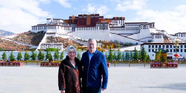 In this May 22, 2019 photo released by the U.S. Embassy in Beijing, U.S. Ambassador to China Terry Branstad and his wife Christine pose for a photo in front of the Potala Palace in Lhasa in western China's Tibet Autonomous Region. (U.S. Mission to China via AP, File)