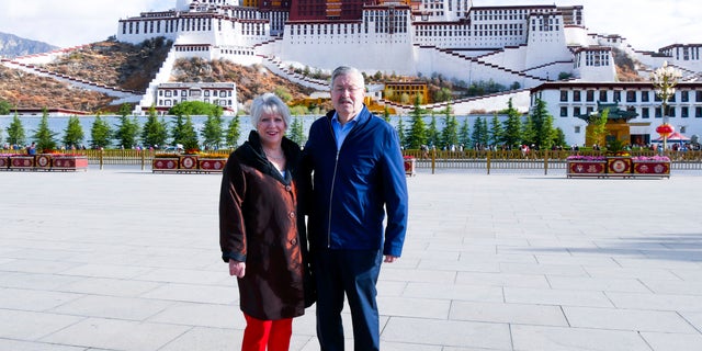 In this May 22, 2019 photo released by the U.S. Embassy in Beijing, U.S. Ambassador to China Terry Branstad and his wife Christine pose for a photo in front of the Potala Palace in Lhasa in western China's Tibet Autonomous Region. (U.S. Mission to China via AP, File)