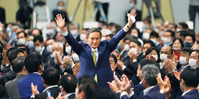 Japanese Chief Cabinet Secretary Yoshihide Suga acknowledges as he is elected as new head of Japan's ruling party at the Liberal Democratic Party's (LDP) leadership election in Tokyo Monday, Sept. 14, 2020. Suga was elected as the new head of Japan’s ruling party on Monday, virtually guaranteeing him parliamentary election as the country’s next prime minister. (Kyodo News via AP)