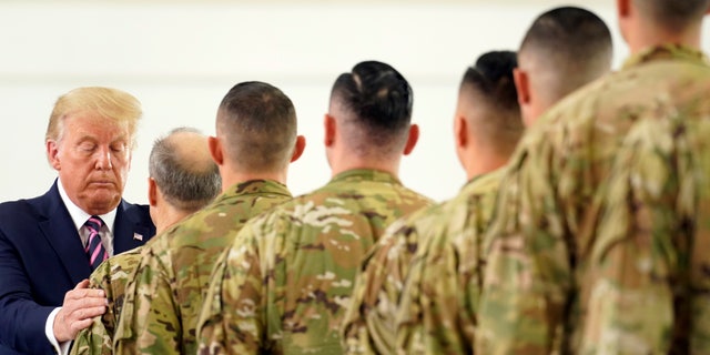President Donald Trump participates in a ceremony recognizing the California National Guard at Sacramento McClellan Airport, in McClellan Park, Calif., Monday, Sept. 14, 2020, after being briefed on wildfires. (AP Photo/Andrew Harnik)
