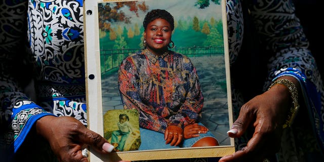FILE: Antoinette Dorsey-James holds a picture of her sister Pamela Turner during a news conference outside the Harris County Civil Court in Houston.