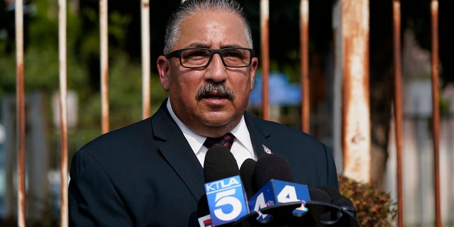 Ron Hernandez speaks to reporters outside St. Francis Medical Center on Monday in Lynwood, Calif., where two Los Angeles County Sheriff's deputies are hospitalized after being shot. (AP Photo/Ashley Landis)
