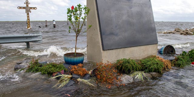 The Hurricane Katrina monument is surrounded by rising water in eastern St. Bernard Parish, La., evacuate for Hurricane Sally on Sept. 14. (Chris Granger/The Advocate via AP)