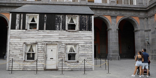 The house of U.S. civil rights campaigner Rosa Parks, rebuilt by artist Ryan Mendoza, is on display in the courtyard of an 18th century Royal Palace, in Naples, Italy, Tuesday, Sept. 15, 2020. It’s the latest stop for the house in a years-long saga that began when Parks’ niece saved the tiny two-story home from demolition in Detroit after the 2008 financial crisis. (AP Photo/Gregorio Borgia)
