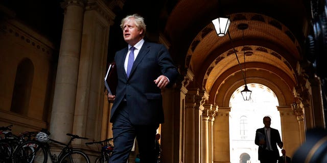 Britain's Prime Minister Boris Johnson walks to his office in Downing Street after a cabinet meeting in London, Tuesday, Sept. 15, 2020.(AP Photo/Frank Augstein)
